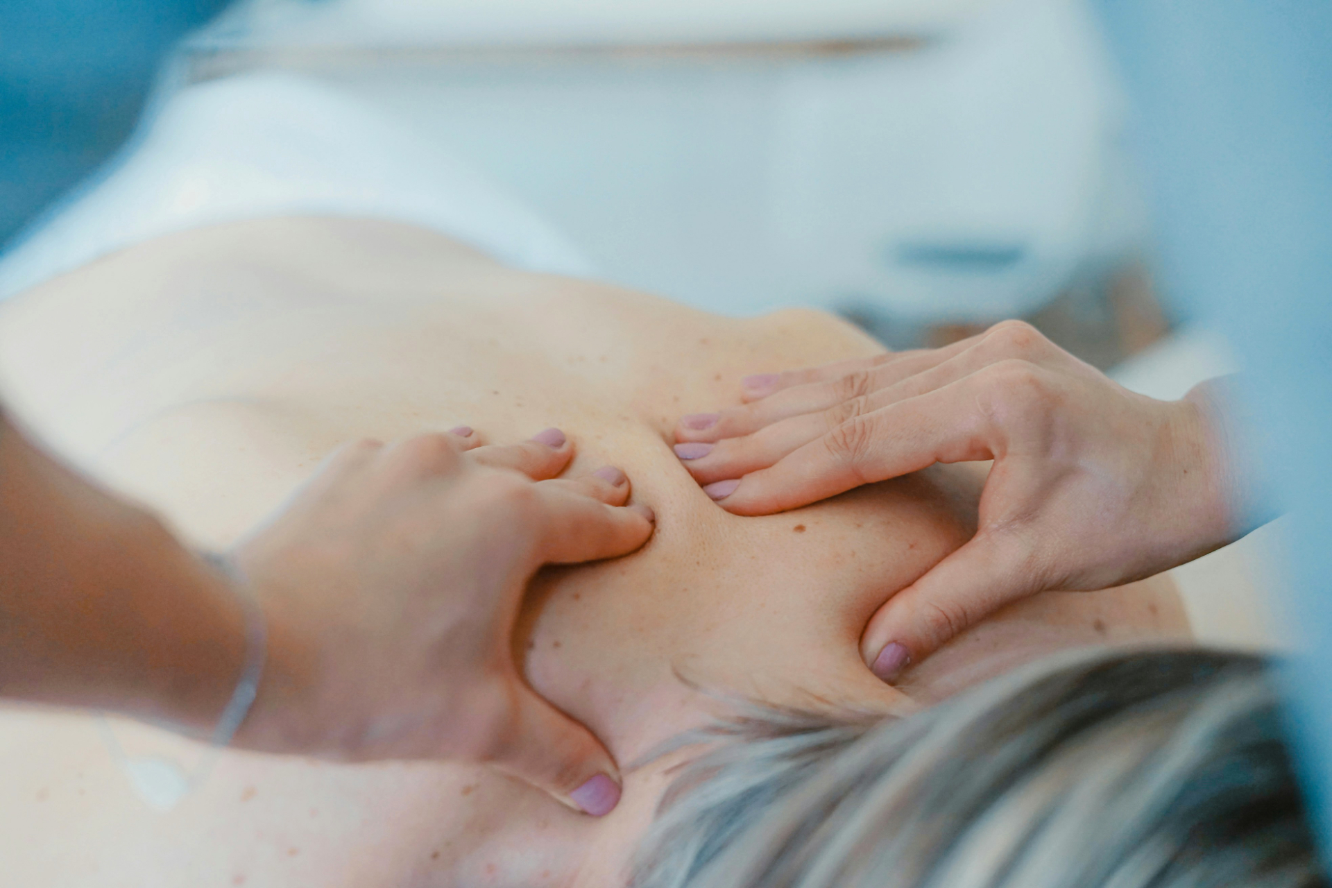 A lady receiving a neck massage shot from above
